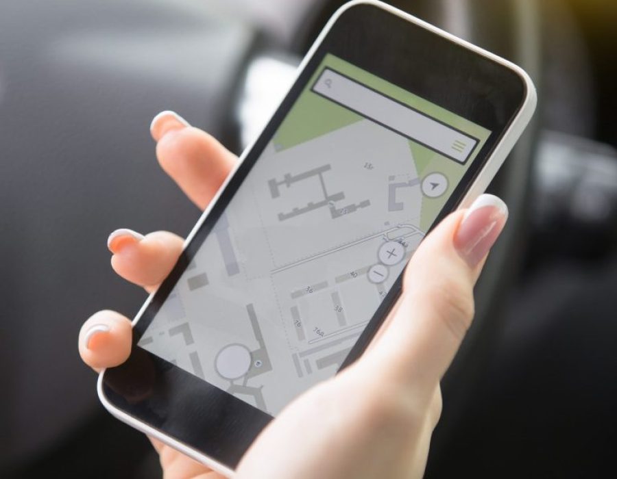 closeup-female-hand-holding-smart-phone-using-navigation-syst-scaled-e1709143635966-768x683
